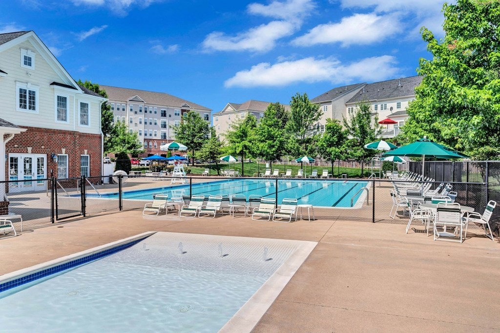 our apartments have a resort style pool with chairs and tables