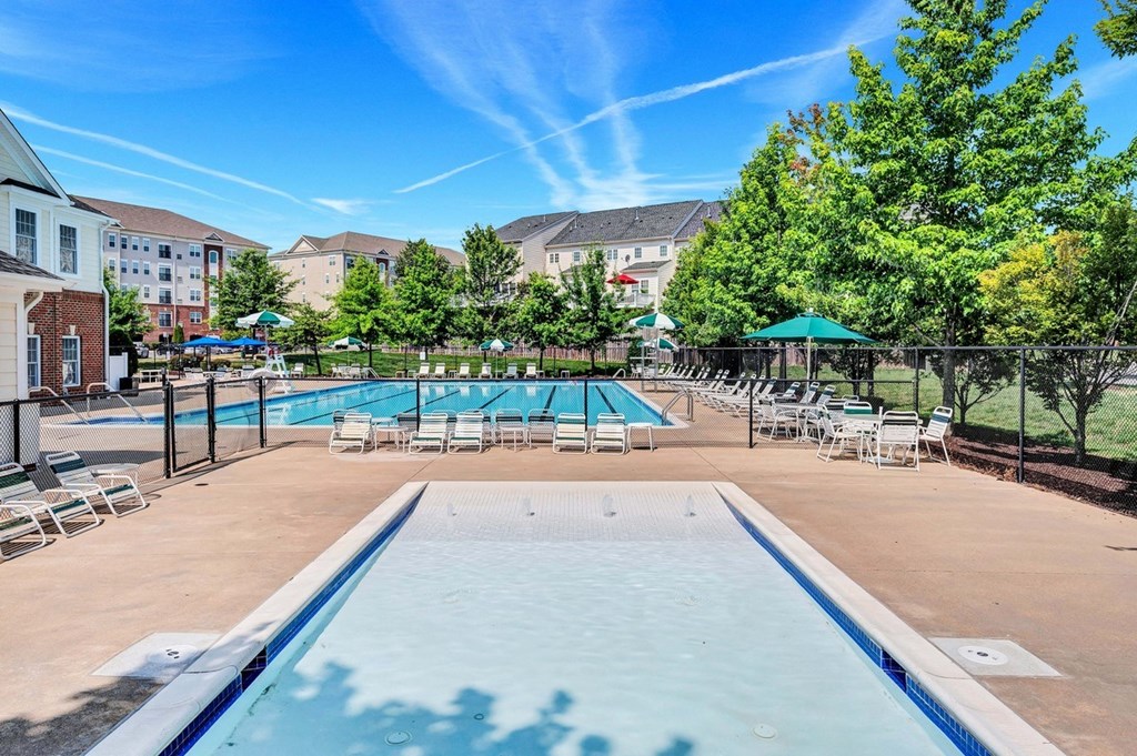 our apartments have a resort style pool with chairs and umbrellas