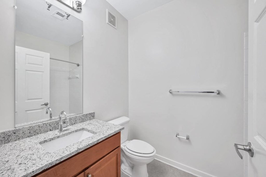 a bathroom with a sink toilet and a mirror