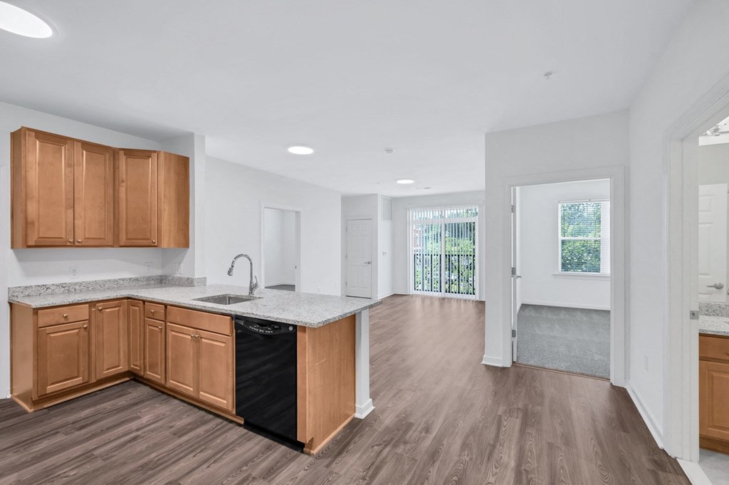 an empty kitchen with wooden cabinets and a counter top