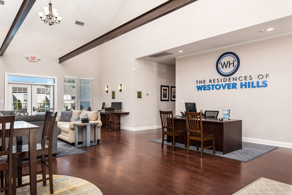 a room with a desk and chairs and a sign that says the residences of westover hills