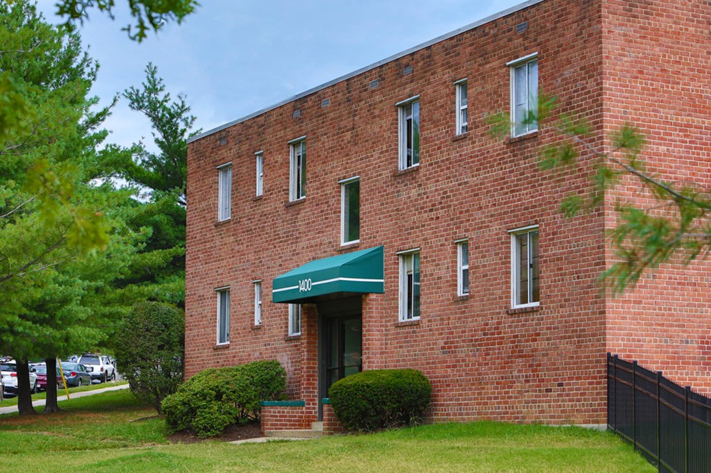 an old brick building with a green awning