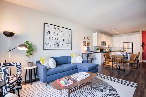 A living room with a blue couch and a coffee table.