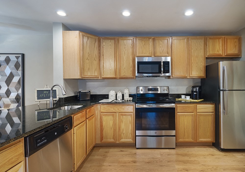 A kitchen with wooden cabinets and stainless steel appliances.