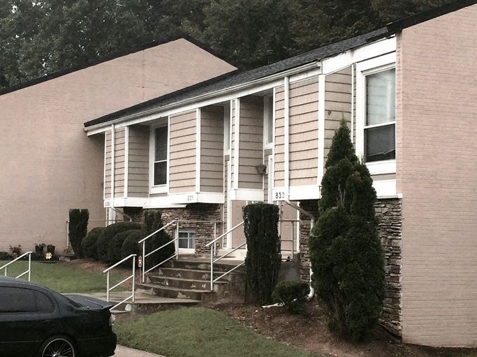 a white house with a car parked in front of it