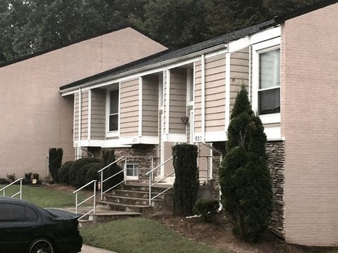 a white house with a car parked in front of it