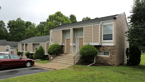 an apartment building with a car parked in front of it
