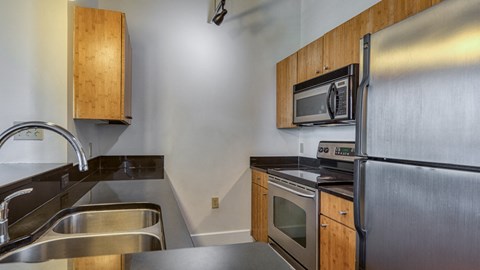 a kitchen with stainless steel appliances and wooden cabinets