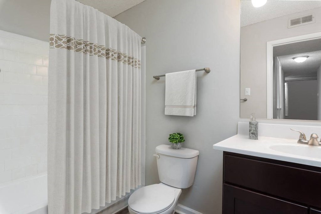a bathroom with a toilet sink and shower