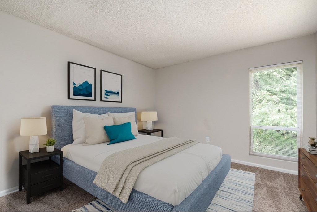 a bedroom with a large bed and two night stands with lamps