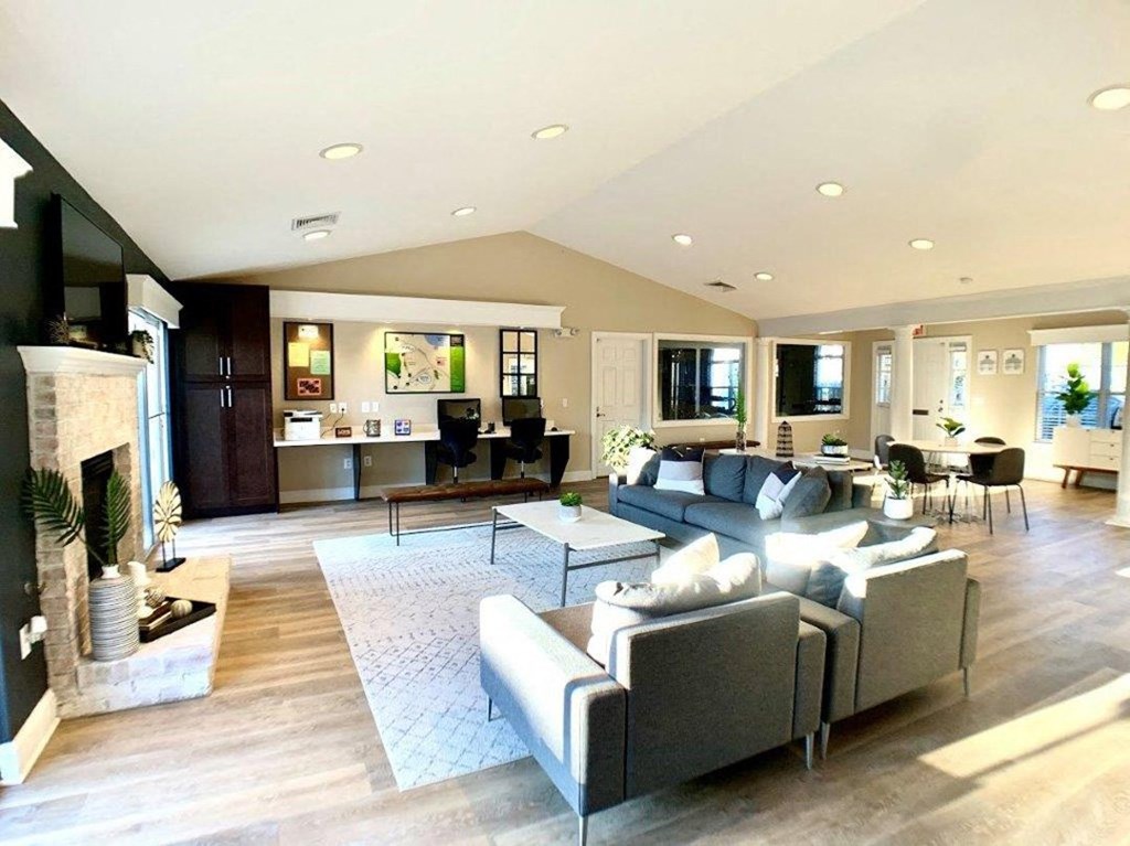 a large living room with furniture and a fireplace