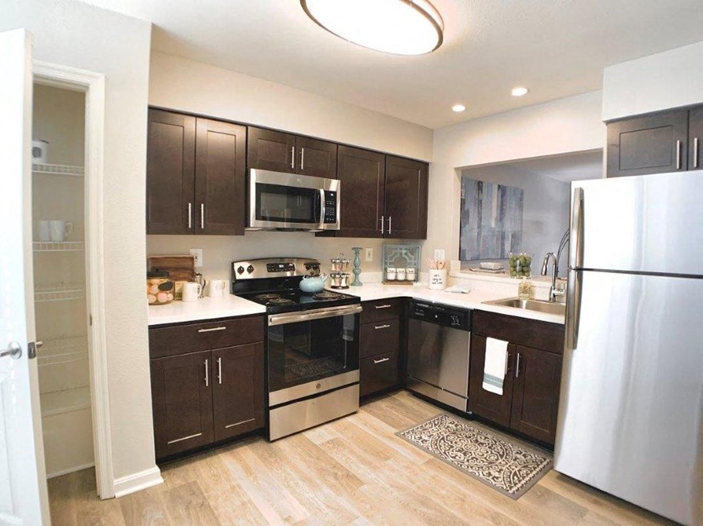 a kitchen with stainless steel appliances and wooden cabinets