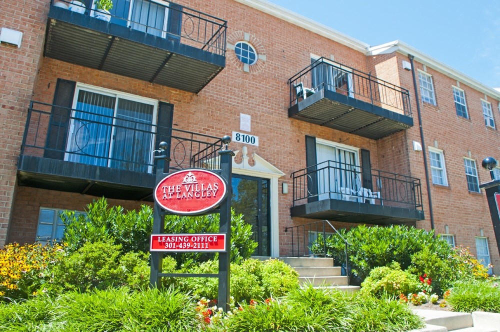 a brick building with a red sign in front of it