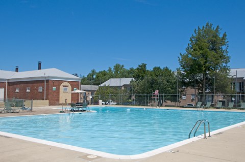 a swimming pool with a building in the background
