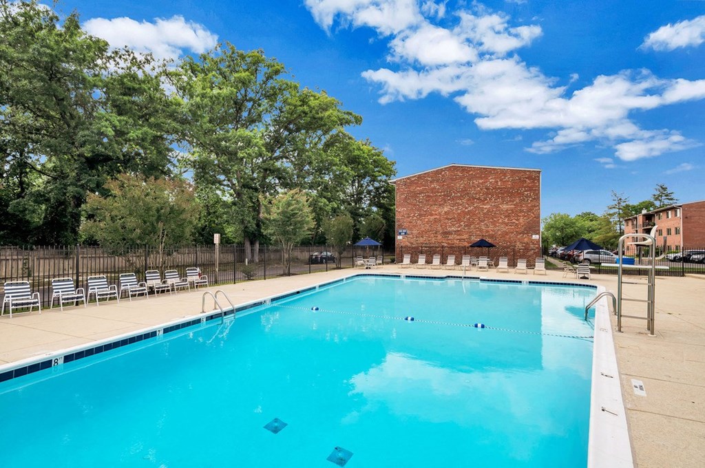 a swimming pool with a brick building in the background