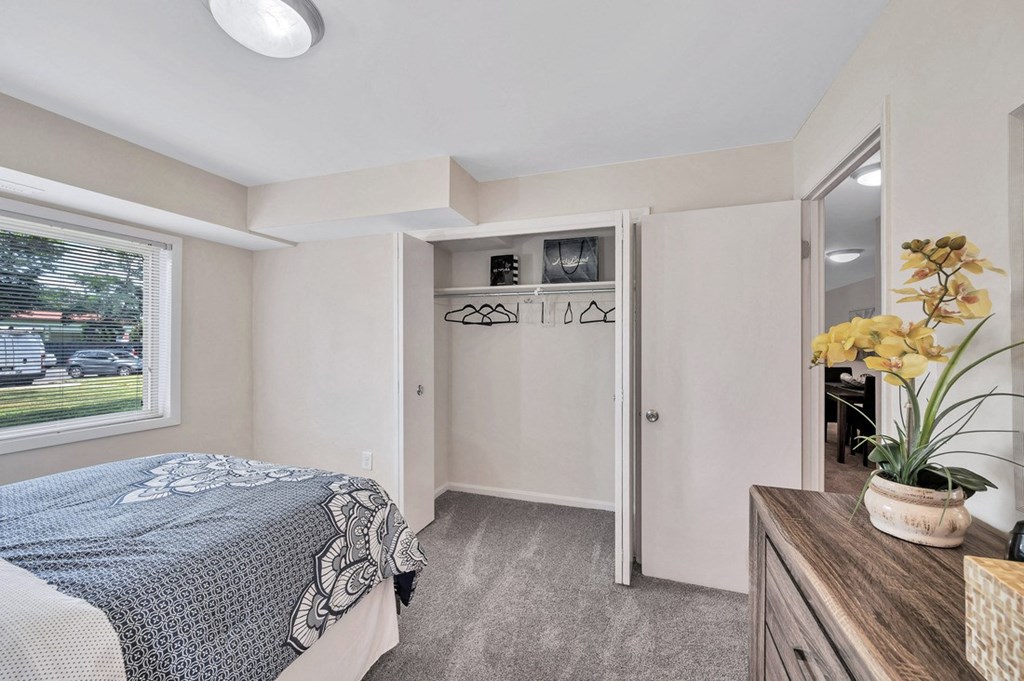 a bedroom with a bed and a mirror