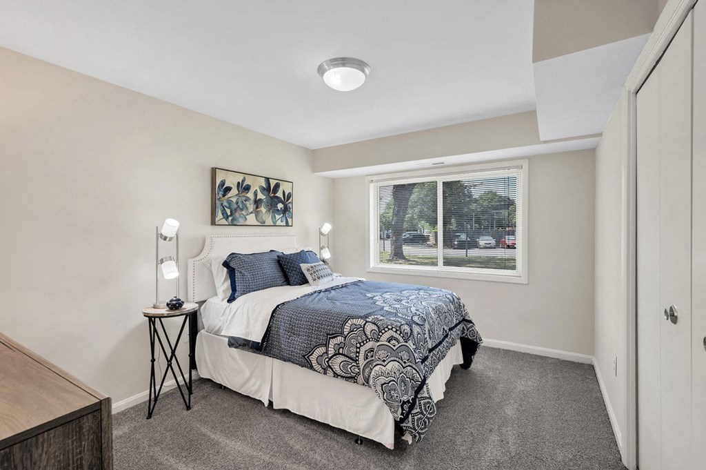 a bedroom with a bed and a window