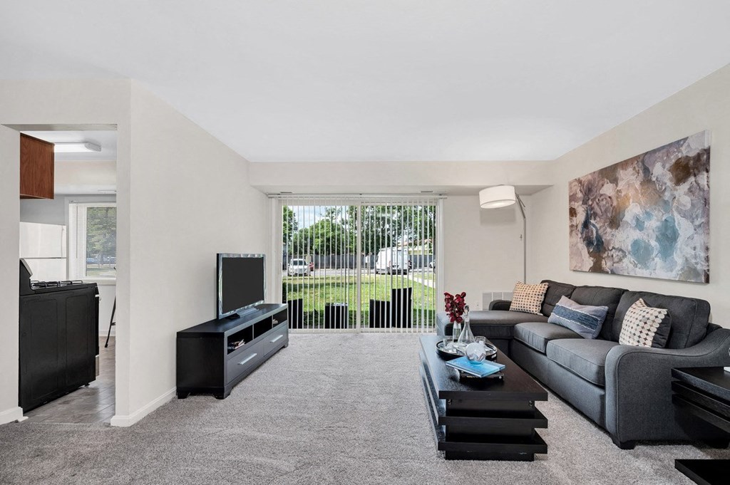 a living room with a gray couch and a black coffee table