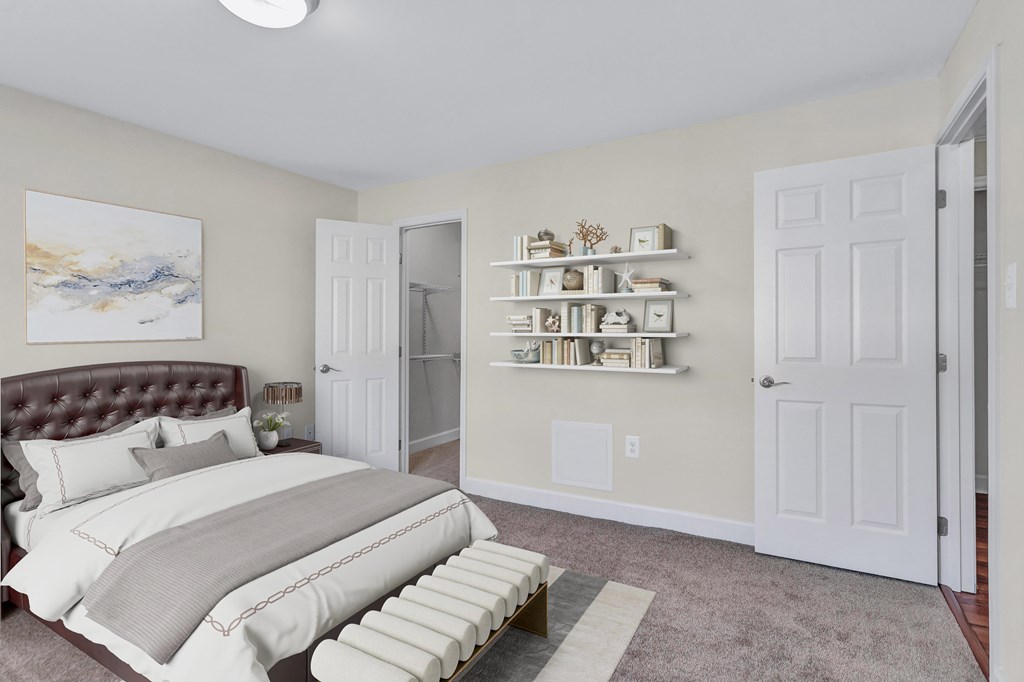 A bedroom with a large bed and a painting on the wall.
