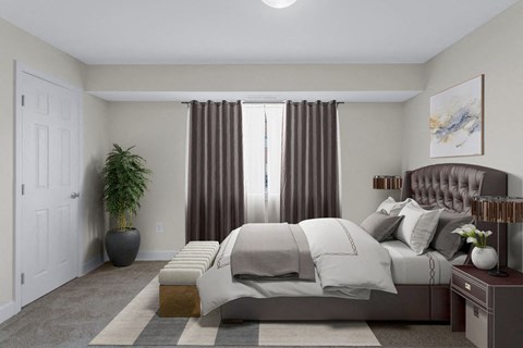 A bedroom with a large bed and a potted plant.