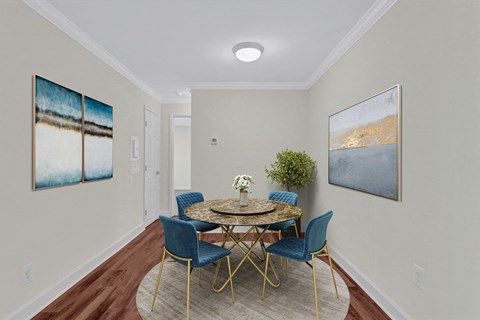 A dining room with a round table and blue chairs.