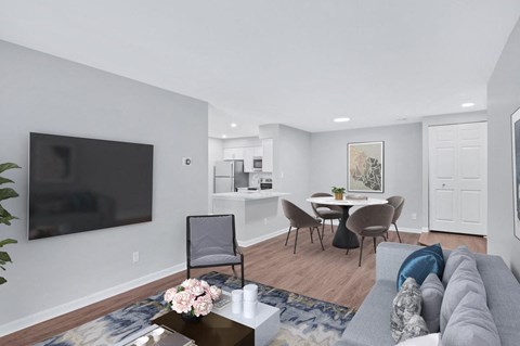 a living room with a couch and a table with chairs
