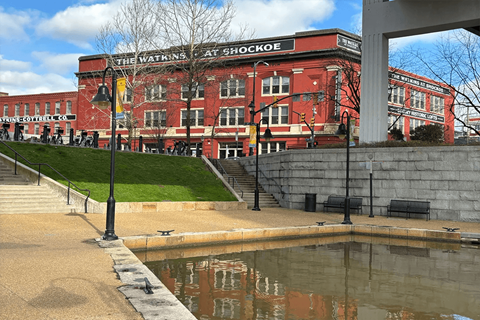 a large red building with a pond in front of it