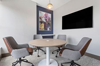 a meeting room with a table and chairs