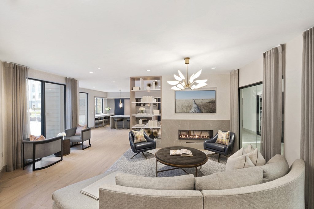 a living room with a couch and chairs and a fireplace
