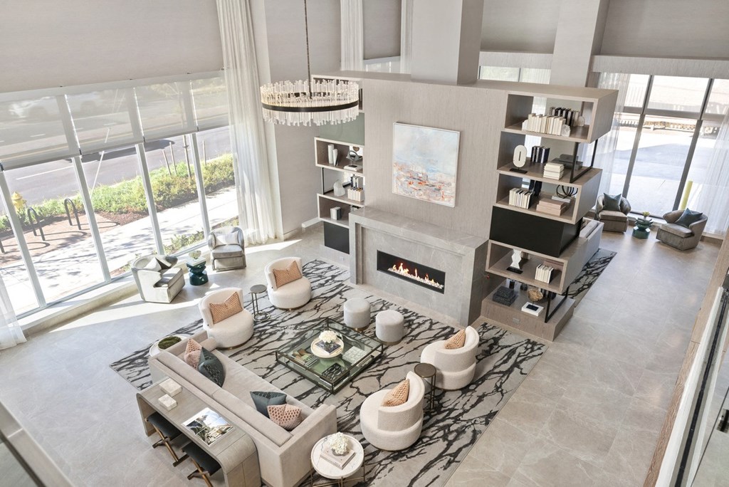 a living room with a fireplace and large windows