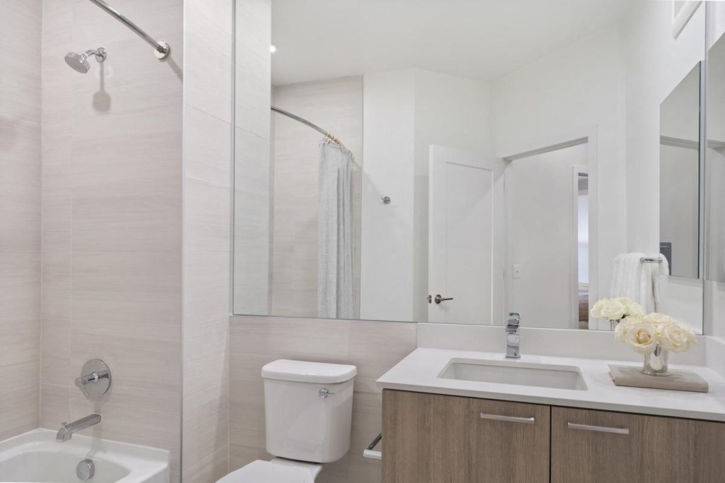 a bathroom with a toilet sink and a mirror