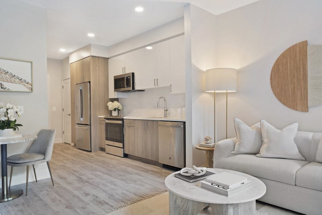 a living room with a couch and a kitchen
