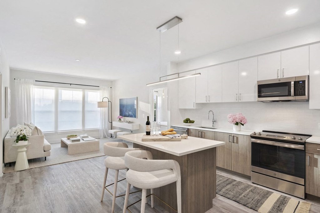 an open kitchen and living room with a table and chairs