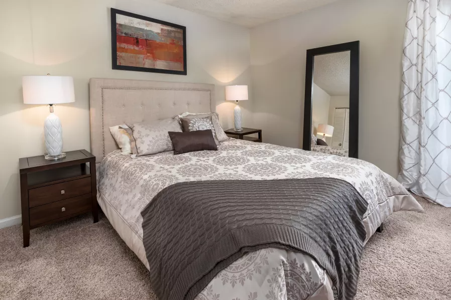 a bedroom with a bed and a mirror