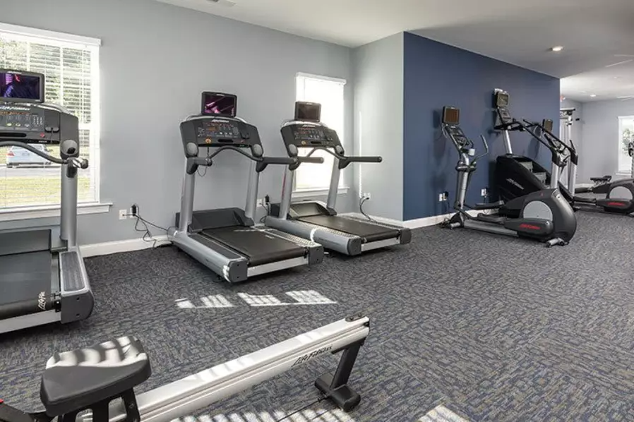 a gym with treadmills and other exercise equipment