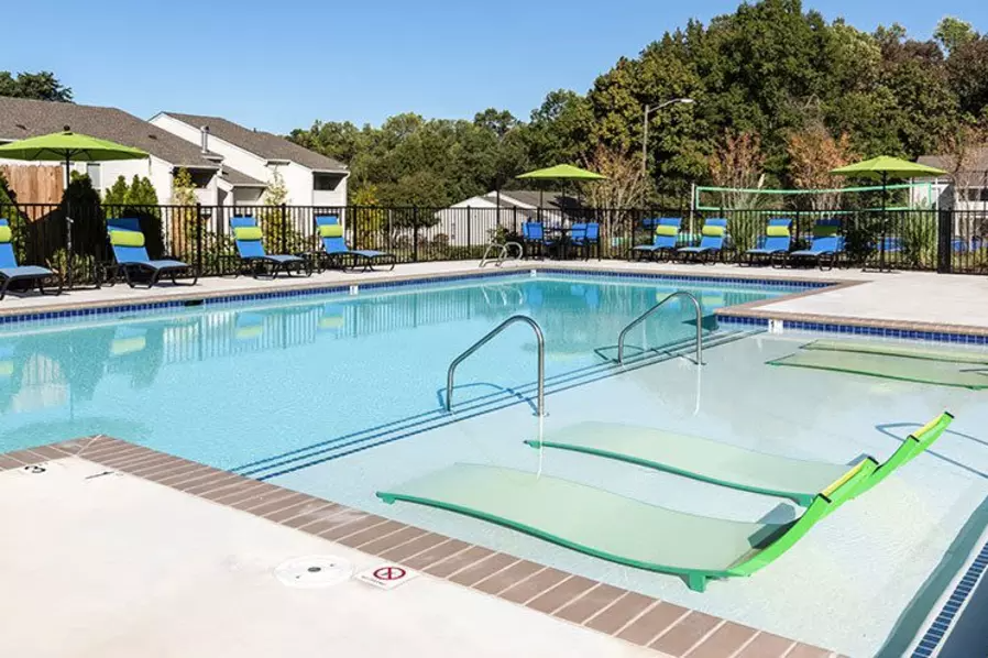 a swimming pool with chairs and umbrellas