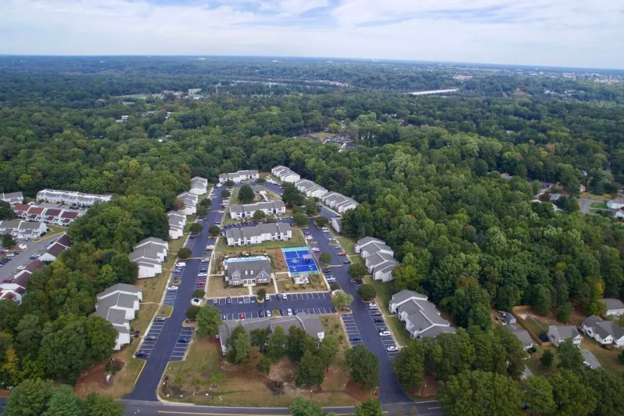 an aerial view of a neighborhood of houses and parking lot
