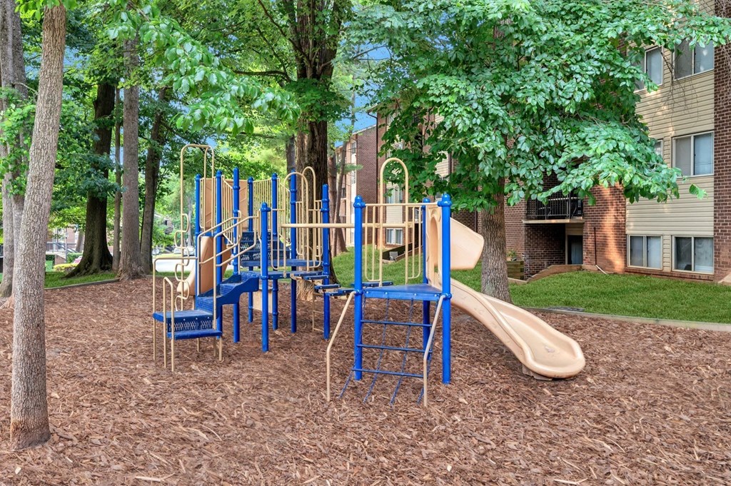 a playground with slides and chairs
