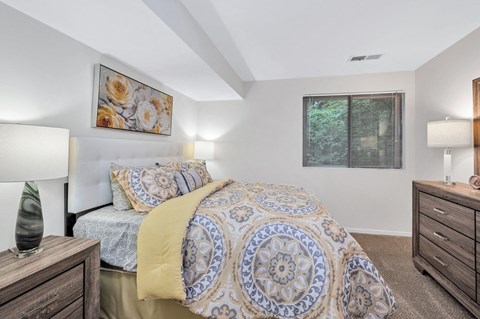 a bedroom with a bed and two night stands
