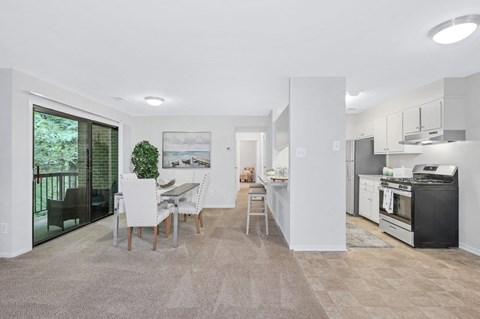 a kitchen and dining room with a table and chairs