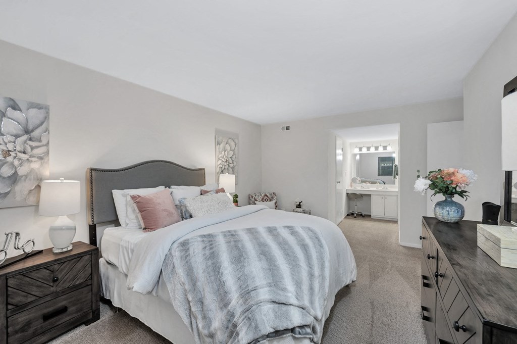 a bedroom with a bed and dresser