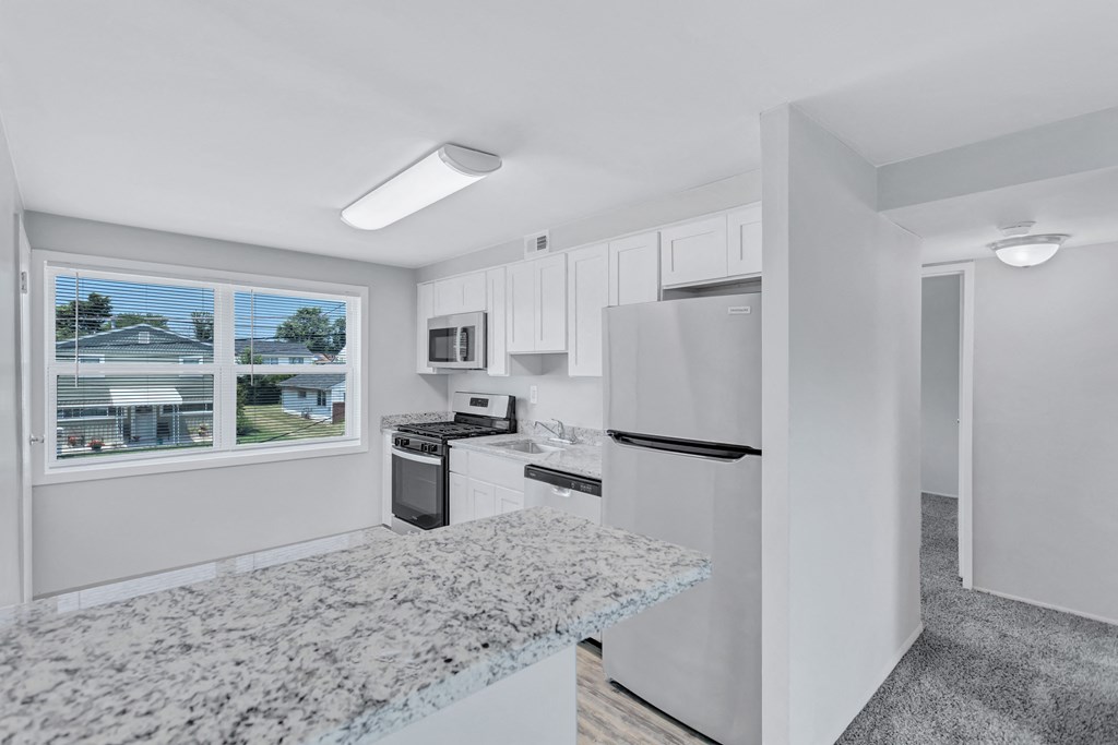 the preserve at ballantyne commons apartment kitchen with stainless steel appliances and granite counters
