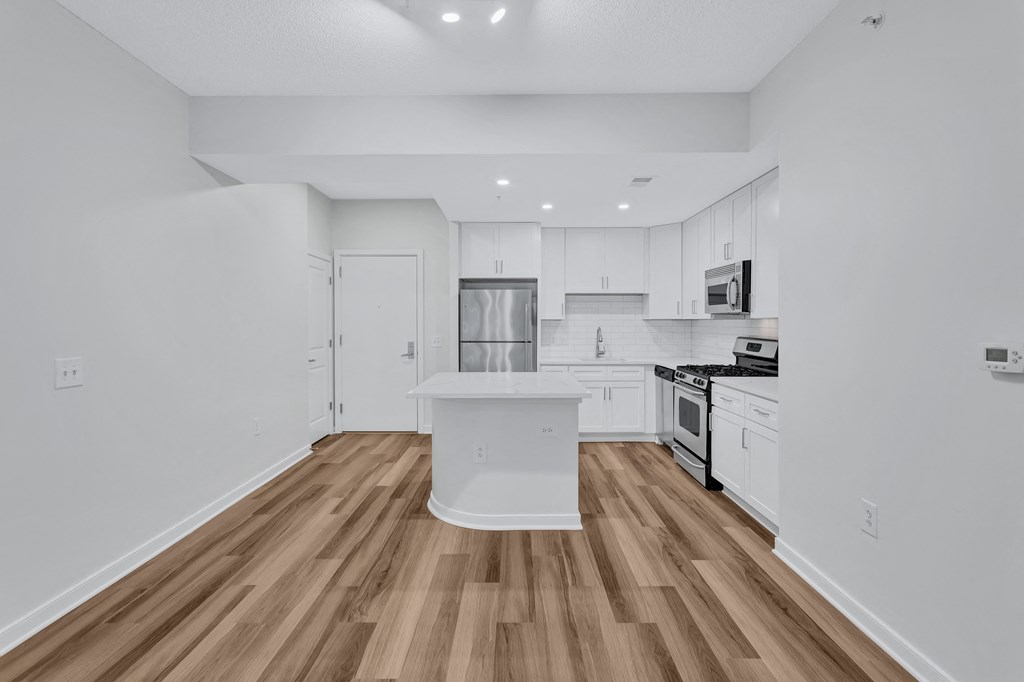 a renovated kitchen with white cabinets and a white counter top