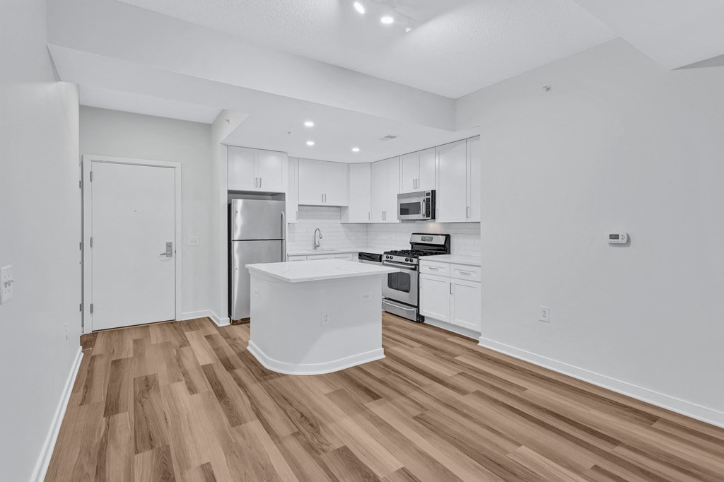 a renovated kitchen with white cabinets and a white counter top