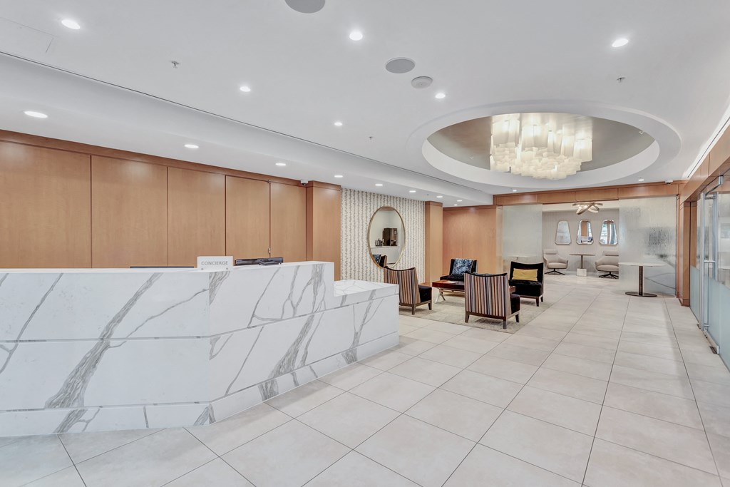 a lobby with a reception desk and a table with chairs