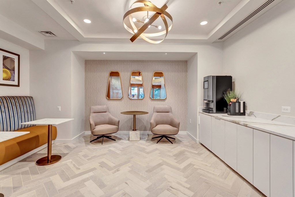 a living room with two chairs and a table and a ceiling fan