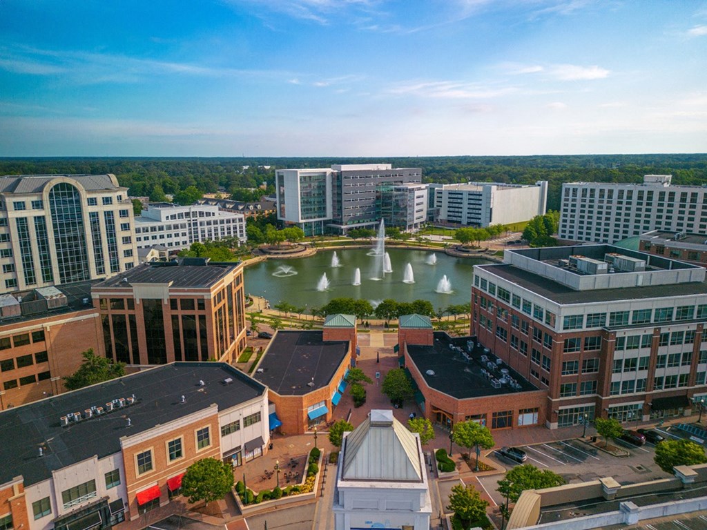 A cityscape with a fountain in the center.