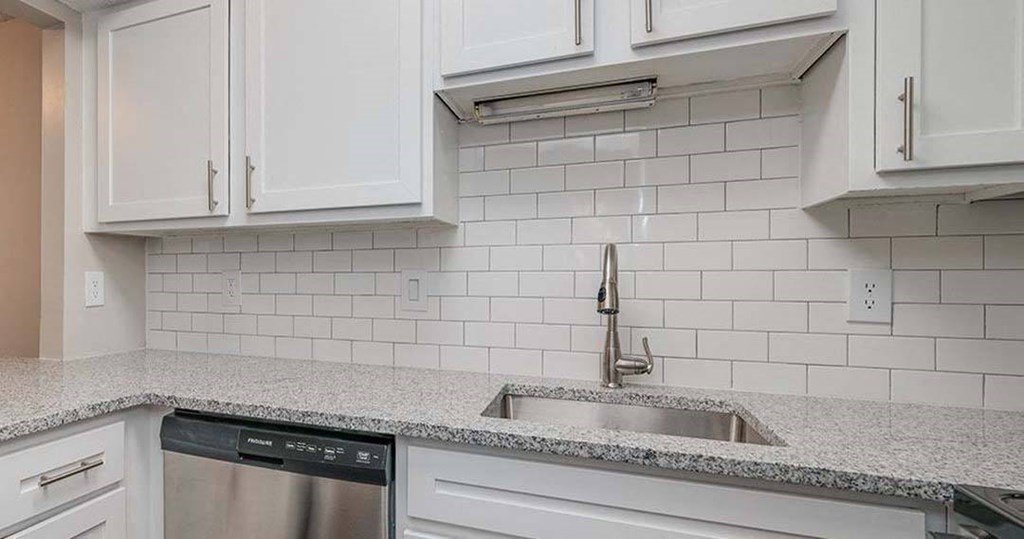a kitchen with white cabinets and a sink