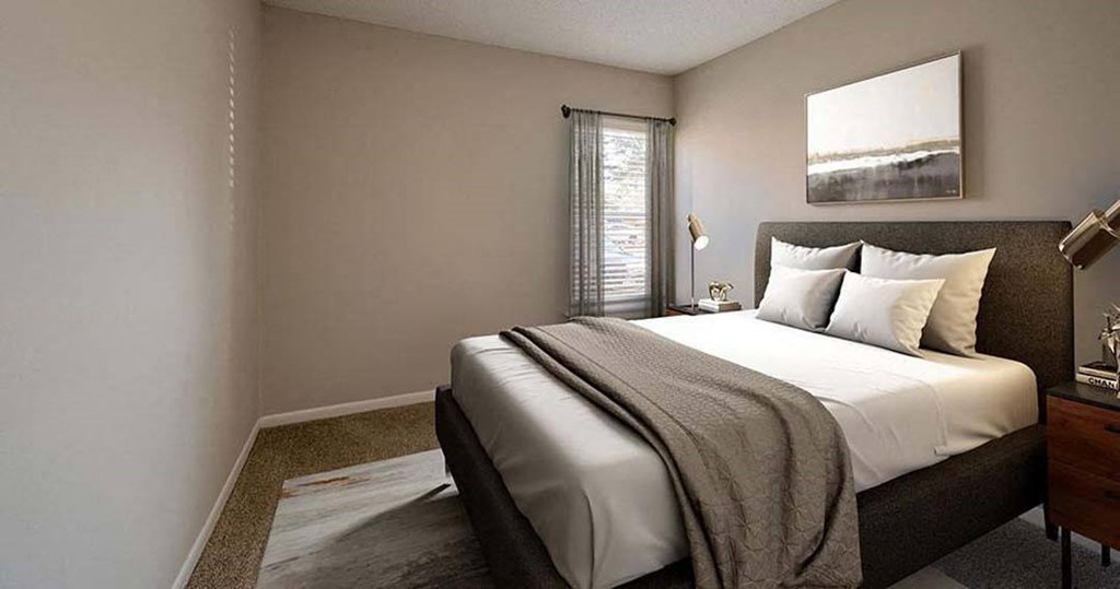 a bedroom with a large bed and a window