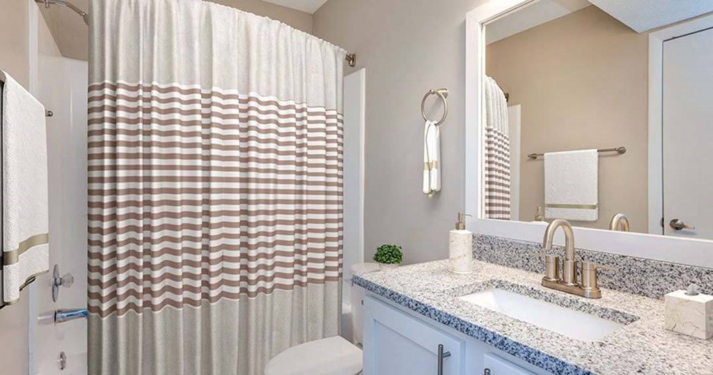 a bathroom with a shower curtain and a sink